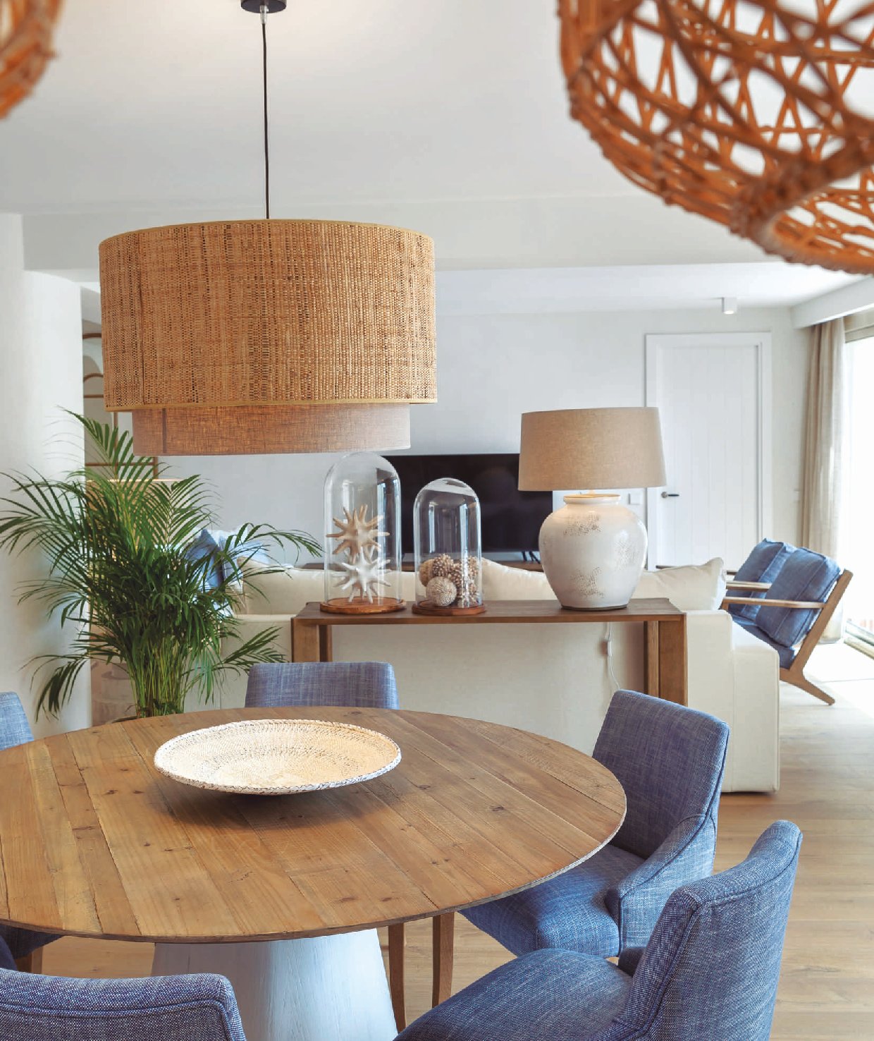 Bright Coastal Dining Room with Round Wooden Table and Blue Chairs — Brucs 2026 Catalog Page 286